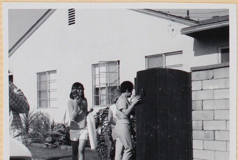 women walking through gate in driveway (ddr-densho-522-96)