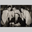 John H. Wilson signing a document while three men look on (ddr-njpa-2-905)