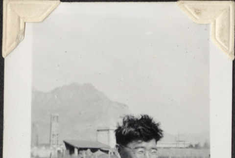 Man with glasses with tents in background (ddr-densho-466-711)
