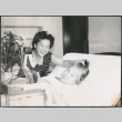 Agnes Sakura sitting by Hideko Kondo laying in bed (ddr-densho-523-331)