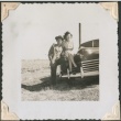 Young man leansing against a woman seated on car (ddr-densho-321-181)
