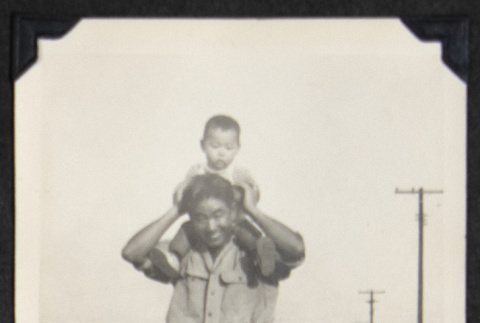 Man with a child on his shoulders (ddr-densho-542-768)
