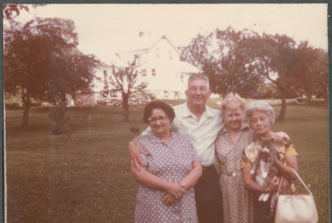 Man and three women with house in background (ddr-densho-523-630)