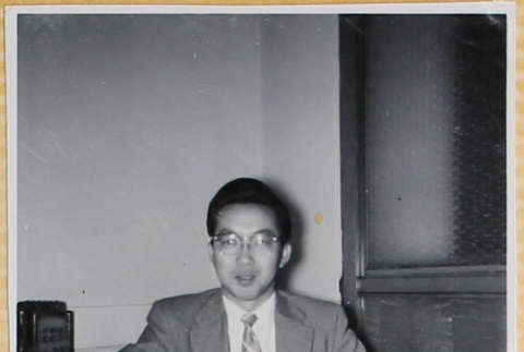 Man sitting at a desk with notebook (ddr-densho-522-22)
