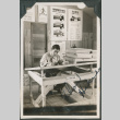 Man sitting at drafting table, signed on front (ddr-ajah-2-483)