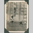 Girl sitting on curb with dog (ddr-densho-316-364)
