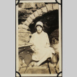Woman sitting in boat under stone bridge (ddr-densho-423-500)