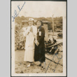 Two women by lumber pile and shed (ddr-densho-316-305)