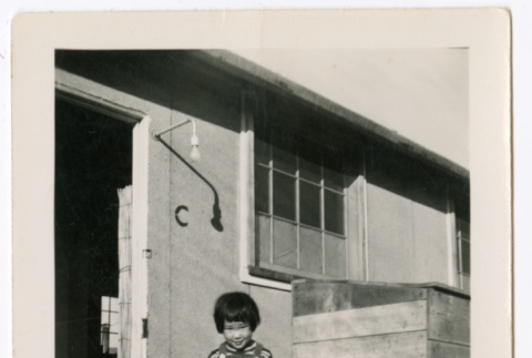 Two children by door of barracks (ddr-densho-329-1337)