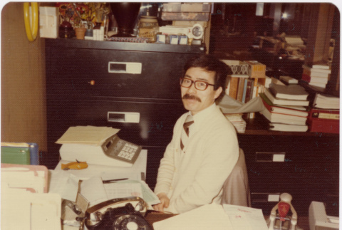 Man seated at desk in office (ddr-densho-426-127)