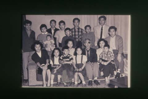 (Slide) - Image of group of people seated and standing around couch (ddr-densho-330-230-master-72bba03af5)