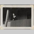 Woman standing on porch (ddr-densho-466-907)