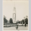 Mabel Sugiyama Eto [?] posing in front of a tower (ddr-densho-298-15)