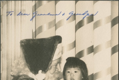 A young girl with Santa Claus (ddr-densho-321-1088)