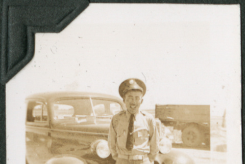 Man standing by car (ddr-ajah-2-400)