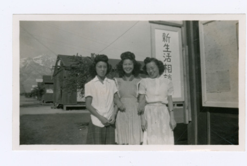 Women in front of Japanese sign (ddr-densho-402-22)