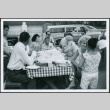 Group sitting at picnic table eating (ddr-densho-293-177)