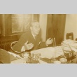 A man seated at his desk (ddr-njpa-1-2237)