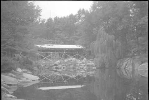 View of house under construction from across pond (ddr-densho-377-1399)
