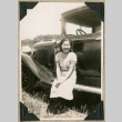 Woman sitting on running board of car (ddr-densho-383-119)