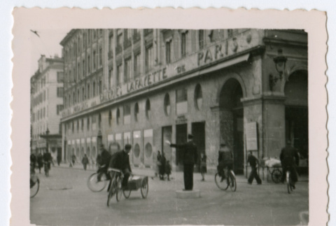 City intersection with man directing traffic (ddr-densho-368-223)