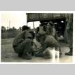 Soldiers sitting behind a truck (ddr-densho-22-238)