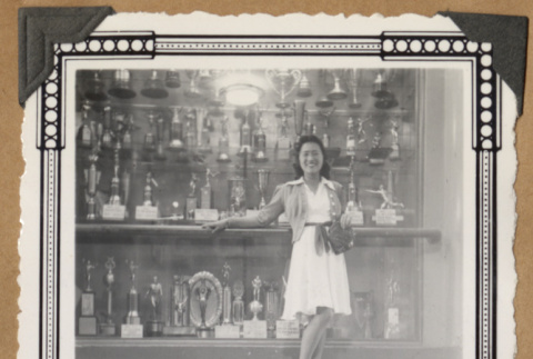 Martha Ito poses next to a trophy case (ddr-densho-542-52)