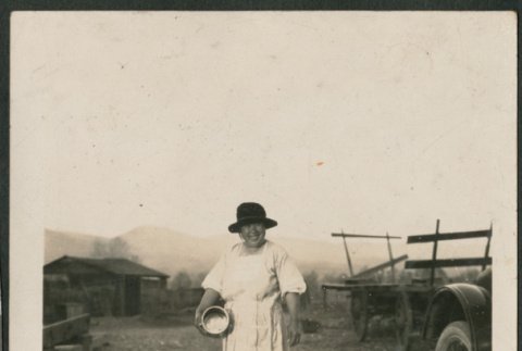 Woman feeding chickens (ddr-densho-293-98)