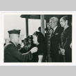 Woman receiving pin from officer (ddr-densho-1007-308)