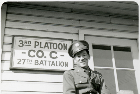 Tom Kubota in uniform in front of 3rd Platoon Co. C 27th Battalion sign (ddr-densho-354-1997)