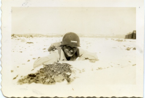 Soldier laying in a field (ddr-densho-22-367)