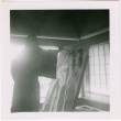 Man painting large canvas (ddr-densho-426-2459)