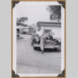 Man leaning on a car bumper (ddr-densho-542-80)