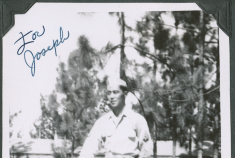 Man standing with rifle.  Signed on front:  For Joseph / Best wishes, Tom (ddr-ajah-2-542)