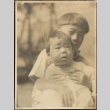 Two Nisei brothers in front of a fence (ddr-densho-259-5)