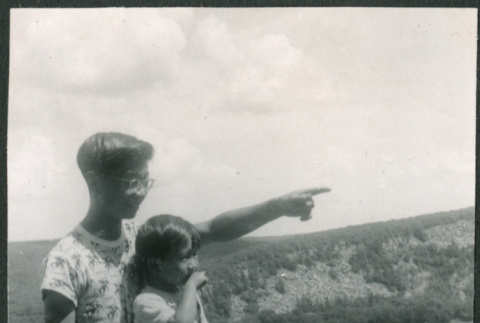 Two boys sitting on rocky overlook (ddr-densho-523-243)