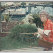 Agnes Sakura by pond with model boat (ddr-densho-523-656)