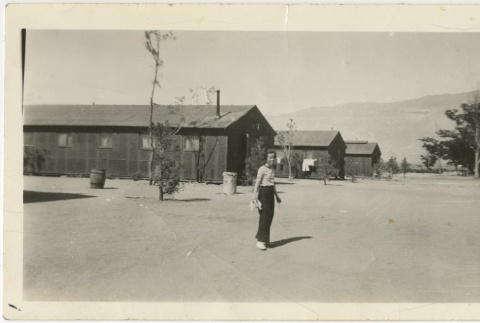 Woman standing on a camp road (ddr-manz-7-47)