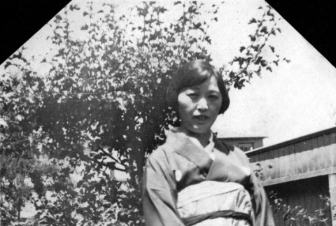 Woman standing in garden in kimono (ddr-ajah-6-267)