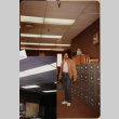 Man standing by filing cabinets (ddr-densho-426-1273)