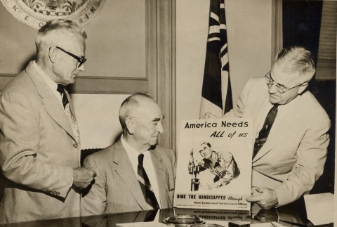 Samuel Wilder King being shown a poster (ddr-njpa-2-103)
