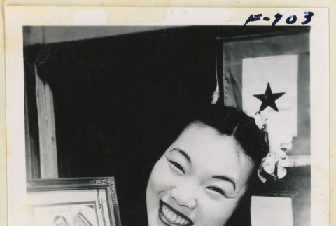 Woman holding a photograph and purple heart (ddr-densho-37-1946)
