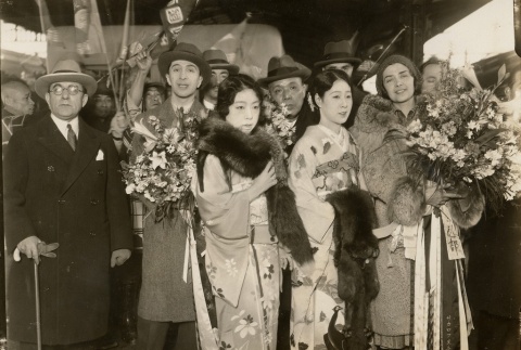 A man and woman being greeted with bouquets (ddr-njpa-1-1882)