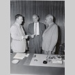 Sears executive giving a check to a University of Hawaii president and dean (ddr-njpa-2-1011)