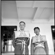 Two men wearing life vests on board ship (ddr-densho-426-267)