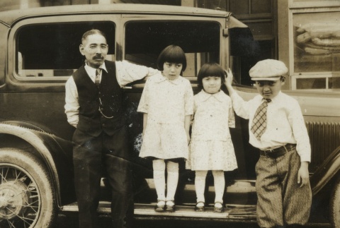 Family in front of car (ddr-densho-128-67)