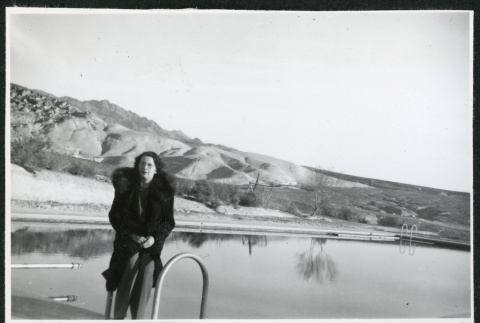 Photograph of Theo Chamberlain standing in front of a pool in Death Valley (ddr-csujad-47-116)