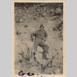 Man leaning against rocky hillside (ddr-densho-466-358)