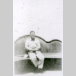 Man on curvy bench (ddr-densho-1007-769)