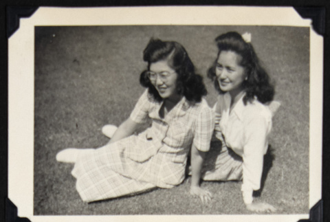 Two women lounge on a lawn (ddr-densho-542-703)